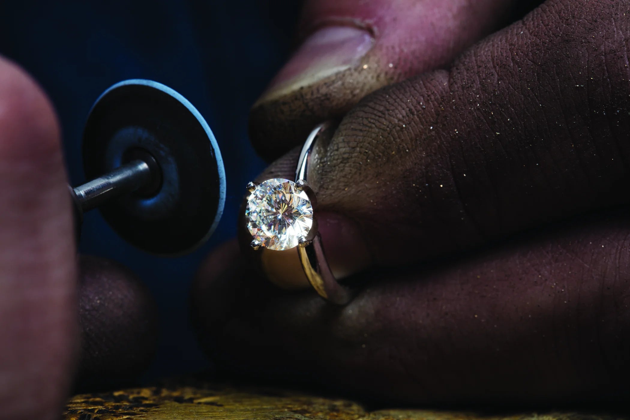 Diamond ring being examined with a loupe by a jeweler.